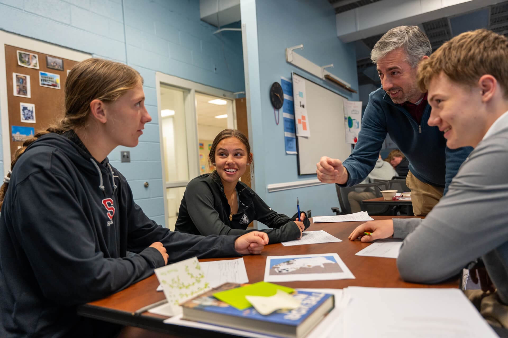 Group of Upper School students talking with teacher